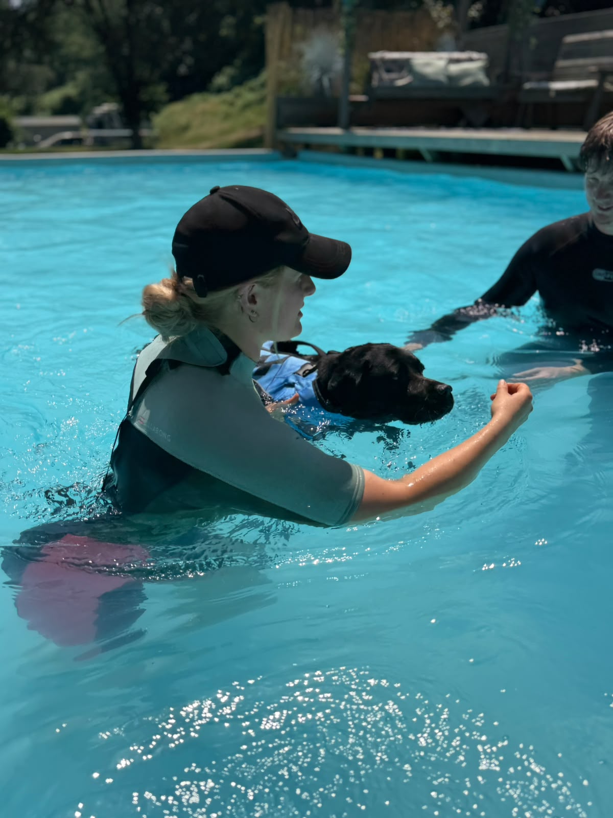 SPLASH team supporting a dog in the water at Duncan's Dog Co.